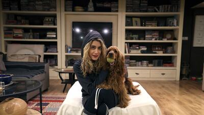 An Iranian woman poses for a picture with with her dog at home in northern Tehran, on December 5, 2021. - A proposed law to ban pets submitted by ultraconservative Iranian lawmakers, pits growing numbers of people with pets against those who consider the practice decadent and hold that under Islamic law dogs, like pigs, are unclean. The bill has sparked criticism in the press, mockery on social networks and anger among residents of the capital. (Photo by ATTA KENARE / AFP)