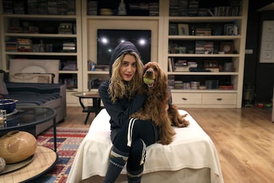 An Iranian woman poses for a picture with her dog at home in northern Tehran. AFP
