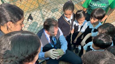 James McDonald, the school's principal, surrounded by pupils at the farm