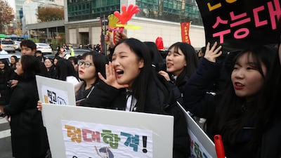 South Korean high school girls cheer for their senior classmates in Seoul, South Korea. Getty Images
