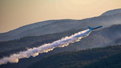 A plane drops water on a fire as it participates in a fire-extinguishing operation in southern Turkey. AP