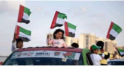 Families show off their decorated cars at the Spirit of the Union Parade at Yas Island.