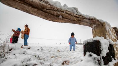 A child walks through a snow-covered field. AFP