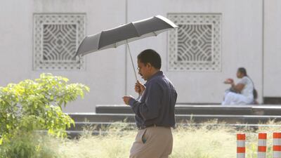As mercury rises, this man makes good use of the umbrella, at Al Ghubaiba-Bur Dubai. Jeffrey E Biteng / The National