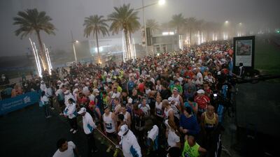 Thousands of Runners line up in the Dubai fog for the start of the race.