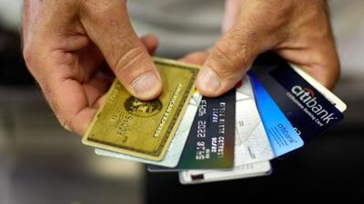 A new survey has found cash-strapped residents in the UAE are using their credit cards to pay their loan obligations. Joe Raedle/Getty Images/AFP