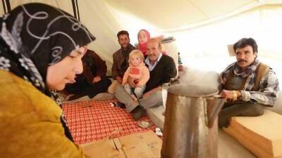 Syrian refugees go about their daily business in a refugee camp in Mafraq, Jordan.