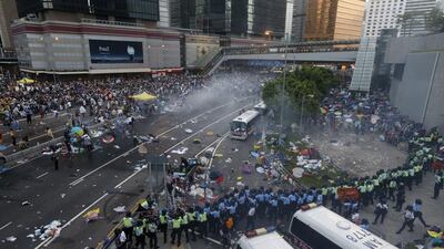 Protesters disperse as riot police fire tear gas. Bobby Yip/Reuters