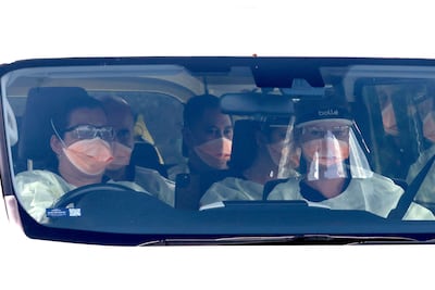 A bus carrying medical officials and members of the flight crew of the plane that transported the passengers caught up in the MV Hondius hantavirus outbreak arrives at the Western Australian city of Perth on Friday. AFP