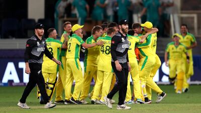 New Zealand's captain Kane Williamson walks past Australian cricketers celebrating. AP Photo
