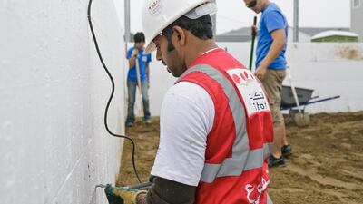 Taleb Al Blooshi, works on the house. he 12 young Emirati men and women who spent last week helping to renovate and build houses in New Jersey, including Ms Morris’s, aim to contribute to the rebuilding effort and also to act as cultural ambassadors for their country.