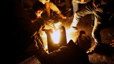 Protesters extinguishing a man who set himself on fire during a demonstration to protest sexual harassment and bullying and demanding rights, in front of the government house in downtown Beirut, Lebanon. AP