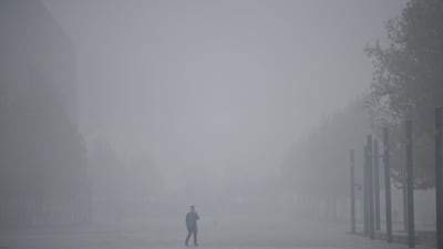 A man uses his mobile phone as he walks amid smog in Tianjin after the city issued a yellow alert for air pollution, China. Reuters