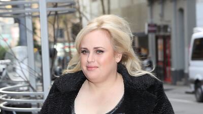 Rebel Wilson, wearing a black and grey striped dress, black coat and a koala clutch, arrives at the Victorian Supreme Court on June 8, 2017 in Melbourne, Australia. Getty Images