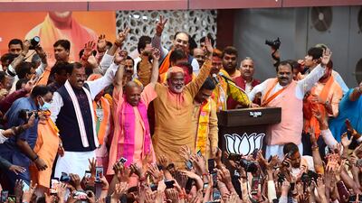 Chief Minister of India's Uttar Pradesh state Yogi Adityanath (wearing pink scarf) gestures to his supporters after BJP's win, in Lucknow. AFP