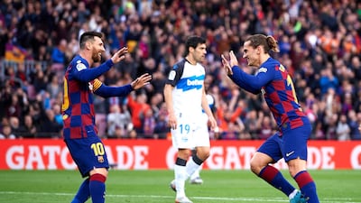 Antoine Griezmann of Barcelona celebrates with his teammate Lionel Messi. Getty