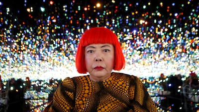 Japanese artist Yayoi Kusama poses for a photograph inside her Infinity Mirrored Room installation in New York. Reuters