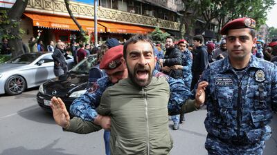 Police restrain a protester during the demonstration in Yerevan. Reuters