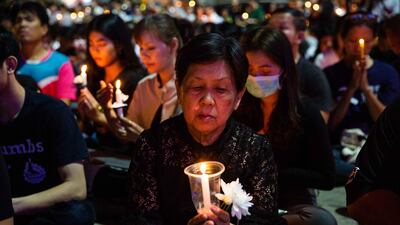 Thai mourners attend a candlelight vigil for the victims of the Terminal 21 Mall shooting on February 9, 2020 in KORAT, Thailand. Getty Images