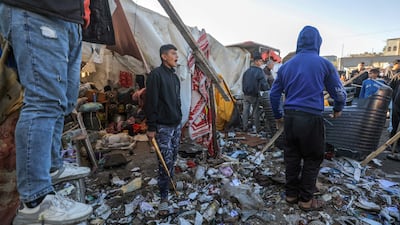 Displaced Palestinians inspect destroyed tents inside Al Dura stadium near Deir Al Balah, in central Gaza, following an Israeli air strike on Sunday. EPA