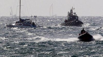 One of the boats that took part in the previous attempt to break Israel's blockade of Gaza is escorted by Israeli naval vessels to Ashdod. Jim Hollander / EPA