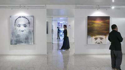 Guests peruse the artwork on display at the Art Hub in Mussafah, the industrial part of Abu Dhabi (Silvia Razgova / The National)