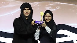 Dana Al Zarouni is presented with her trophy by Sheikha Latifa bint Mohammed, chairwoman of Dubai Culture and Arts Authority. Chris Whiteoak / The National