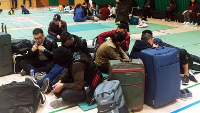 Residents rest at a gymnasium as they take shelter from a forest fire in Goseong. Yonhap / AFP