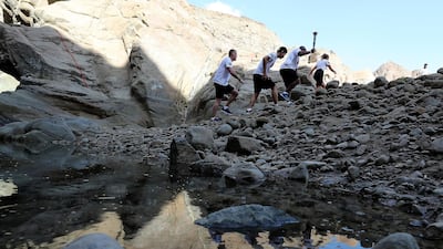 Gary Fournier, Hung Chow, Allen Jones and Delia Newman with the Special Olympics torch “Flame of Hope” in Wadi Al Wurayah Waterfalls in Fujairah. Pawan Singh/The National