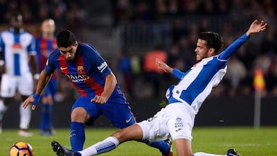 Luis Suarez attempts to take on Espanyol defender Diego Reyes. Josep Lago / AFP