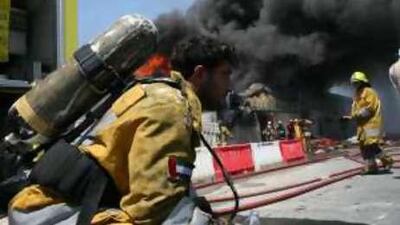 A fireman rests during a warehouse fire in Dubai in March. The combination of high outside temperatures, protective suits and equipment means that heat exhaustion is a risk.