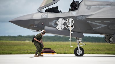 A US Marine Corps officer prepares an F-35B Lightning II before taking off for a live-fire training exercise on Andersen Air Force Base, Guam. Photo: EPA