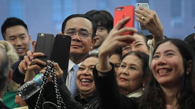 Thailand's Prime Minister Prayut Chan-o-cha, second from left, is swarmed for selfies after a speech at the Asia Society, during his visit to the United Nations General Assembly in New York. AP Photo