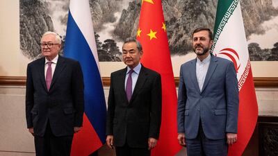 Russian Deputy Foreign Minister Sergey Ryabkov with Chinese Foreign Minister Wang Yi and Iranian Deputy Foreign Minister Kazeem Gharibabadi in Beijing on Friday. Reuters