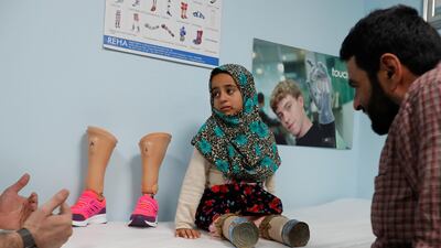 Maya with her father Mohammed at the prosthetic centre in Istanbul. Reuters