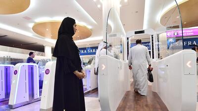 An official looks on as passengers pass through the tunnel. AFP