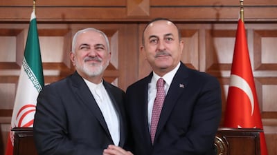A handout photo from Turkish Foreign Ministry Press Office shows Iranian Foreign Minister Mohammad Jawad Zarif shaking hands with Turkish Foreign Minister Mevlut Cavusoglu after their press conference in Ankara. EPA, HO