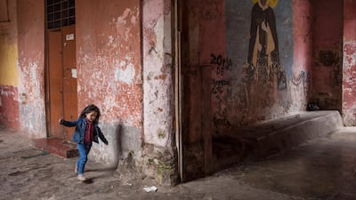 A girl runs inside a house next to where the procession of "The Lord of Miracles", will pass in Lima, Peru. "The Lord of Miracles" is the patron saint of Lima. AP