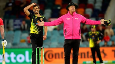 Australian pacer Mitchell Starc smiles as the umpire signals a wide. AFP