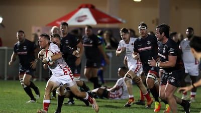 Abu Dhabi Harlequins attempt to break away with the ball against Dubai Exiles.