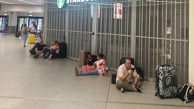 People sit outside the closed Starbucks at Gatwick airport on Sunday. PA Images