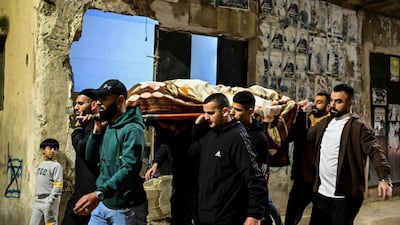 Mourners carry the body of one of three men killed in an Israeli strike that hit a car in Jenin in the occupied West Bank. AFP