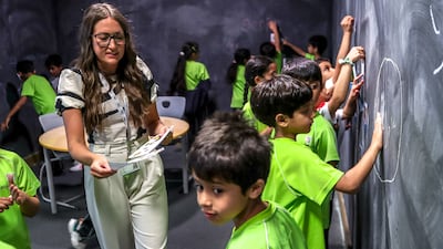 Al Mamoura Academy teacher Amy Louise Locker with pupils in her Year 2 class. All pictures: Victor Besa / The National