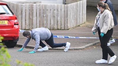 Police search the scene. Getty Images