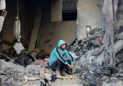 A Palestinian man looks stunned at the scale of destruction at the site of the Israeli strike on Nuseirat refugee camp, Gaza on Friday. Reuters