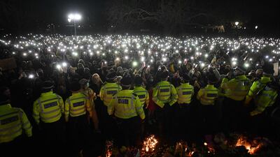 People gathered at Clapham Common, London, UK, to pay their respects to kidnap and murder victim Sarah Everard, turn on their phone torches in tribute. They gathered on Saturday night despite a vigil being cancelled, after police outlawed it due to Covid-19 restrictions. AFP
