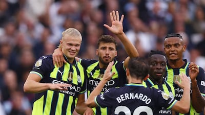 Erling Haaland celebrates scoring his and City's second goal with teammates. Reuters