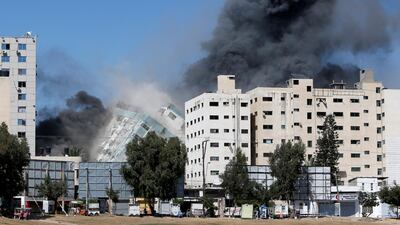 The Gaza city tower housing AP and Al Jazeera collapses after a missile strike on Saturday. Reuters