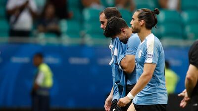 Luis Suarez is consoled by teammates after Uruguay's Copa America quarter-final defeat. AP Photo