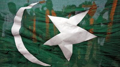 Supporters of Shiv Sena, a Hindu hardline group, are seen through a flag resembling Pakistan's national flag during a protest against the attack on an Indian army camp in Jammu. Mukesh Gupta / Reuters